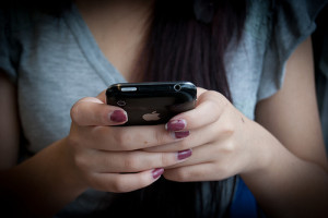 Girl checking her phone about Sororities 