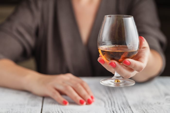 woman with a glass of alcohol