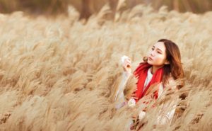 Asian American Woman in Wheat Field working on Mindfulness