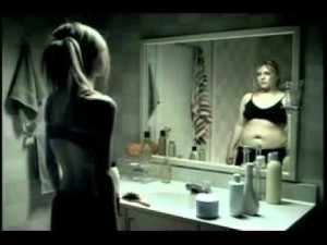 Woman looking at her body weight in the mirror.