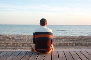 Man with BED on beach