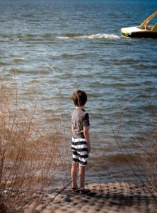 Boy standing on the shore