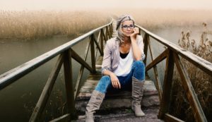 Woman sitting on a bridge struggling with bulimia