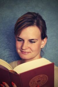 College student reading a thick book about Signs of Depression