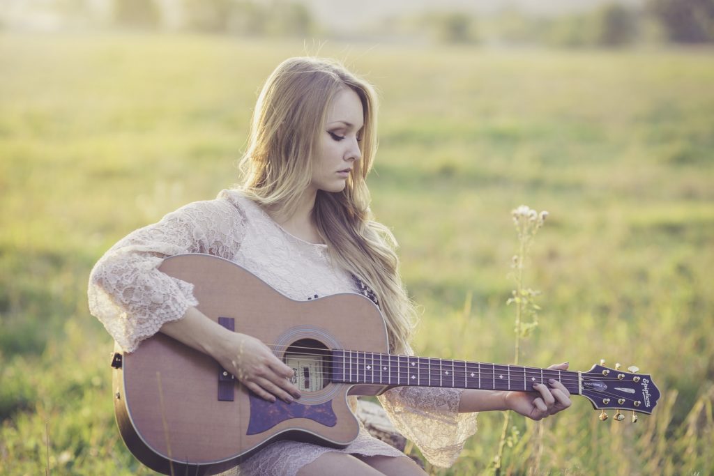 Young woman playing the guitar