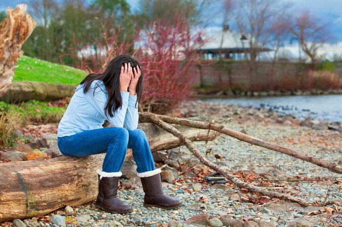 Girl resting along lake