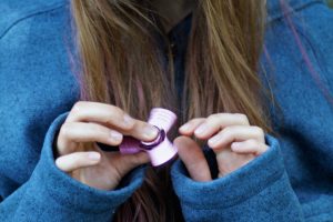 Girl playing with fidget spinner