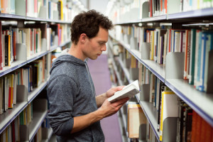 A guy reading about men and Binge Eating Disorder in the library