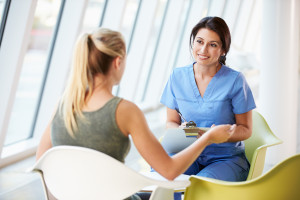 Nurse Meeting With Teenage Girl In Modern Hospital