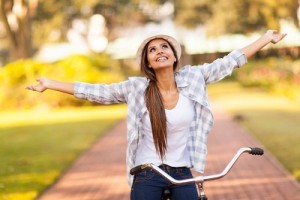 young woman enjoying riding bike because of her Binge Eating Disorder Relapse Prevention Plan