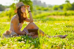 girl with book sitting on grass