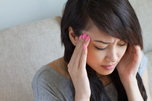 woman with headache, migraine, stress, insomnia, hangover, asian caucasian indoor scene