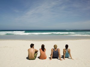 Couples sitting on the beach.