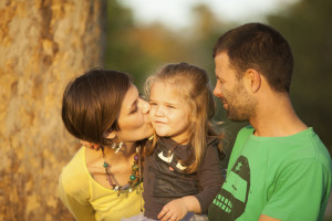 Happy Family Portrait Mother Father And Daughter Outdoor