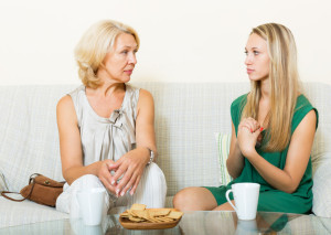 Mature woman with   daughter having serious conversation