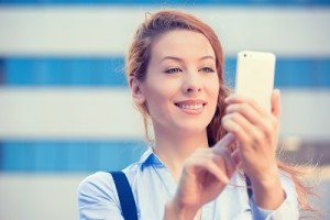 woman hands holding, using smart, mobile phone city background