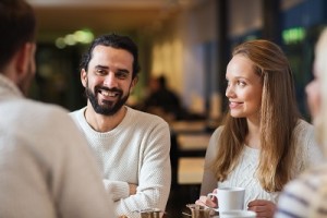 happy friends meeting and drinking tea or coffee