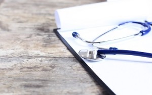 medical history with stethoscope on wooden desk