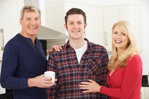 Portrait Of Family With Adult Son At Home