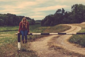 Girl sitting on gate dealing with anxiety disorders