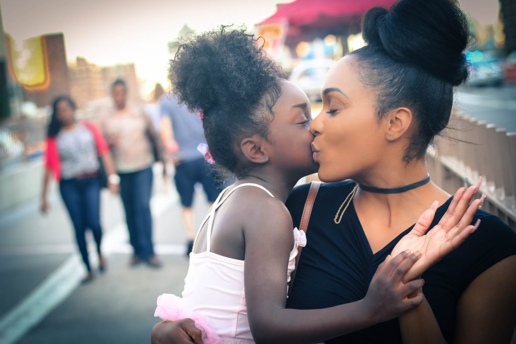 Yong kid struggling with Binge Eating Disorder kissing her mom