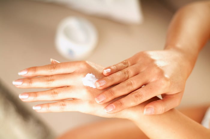 putting cream on hands