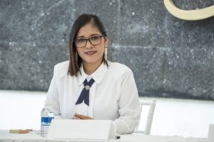 Hispanic Woman in Business Meeting Room