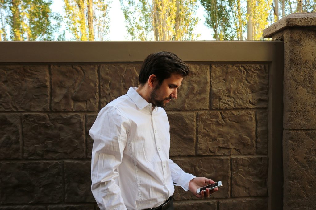 Man researching exposure-based therapy on his smart phone.