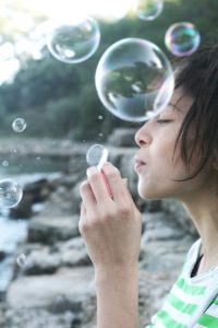 Woman blowing bubbles