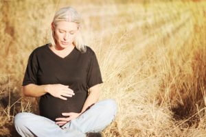 Woman struggling with Pregorexia in a wheat field