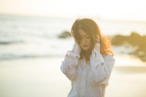 Woman Walking On The Beach facing domestic abuse