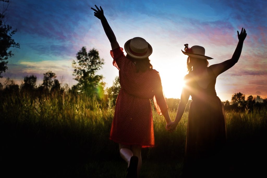 Women watching sunset and sharing friendship