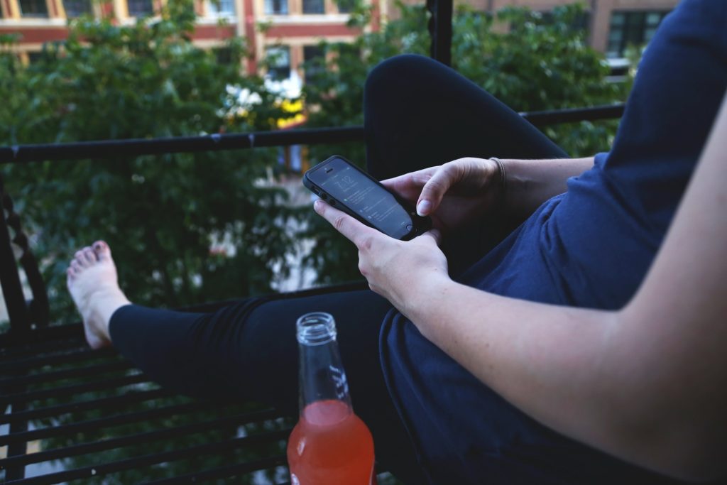 Woman using her phone to check Instagram