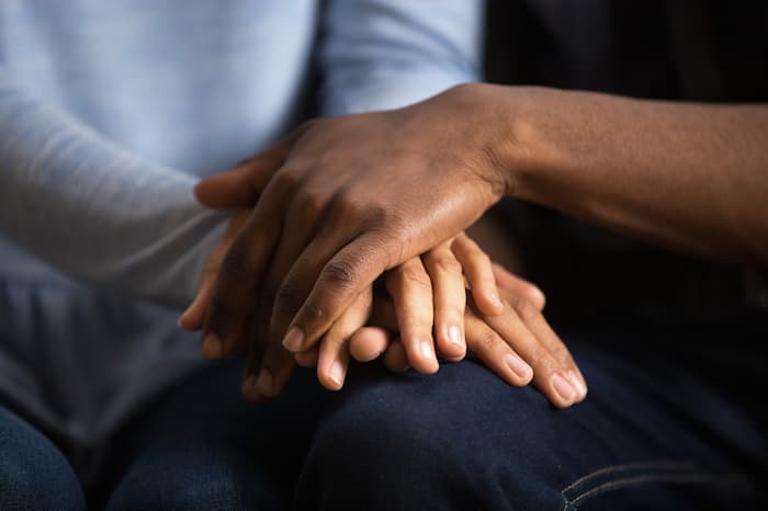 holding hands to show support