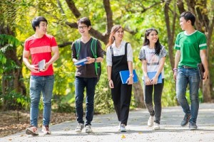 Asian University students walking through the park on their way