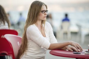 Woman with body image issues sitting at a table