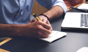 Man writing plan for Balancing College and Recovery