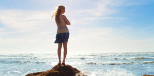 Girl Facing Sea on Rocks